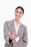 Business card being handed over by smiling saleswoman