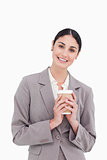Smiling businesswoman holding paper cup