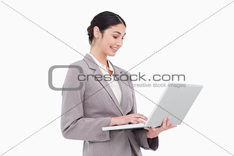 Side view of businesswoman using laptop