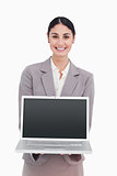 Smiling businesswoman showing screen of her laptop