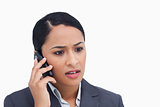 Close up of negative surprised saleswoman on her cellphone