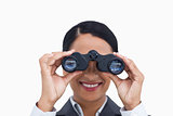 Close up of smiling saleswoman using spy glasses
