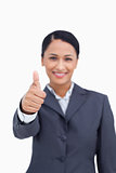 Close up of thumb up being given by smiling saleswoman