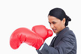 Close up side view of aggressive saleswoman with boxing gloves