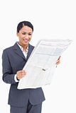Close up of smiling saleswoman reading the news paper