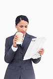 Close up of saleswoman with paper cup and news paper