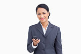Close up of smiling saleswoman holding cellphone