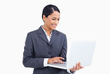 Close up of smiling saleswoman using her laptop