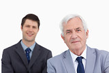 Close up of mature businessman with colleague behind him