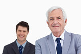 Close up of mature businessman with employee behind him