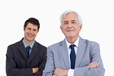 Close up of mature businessman with folded arms and colleague be