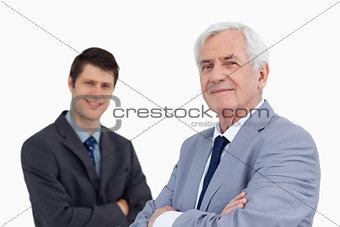 Close up of smiling businessmen with arms folded