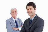 Close up of smiling businessman with his mentor behind him