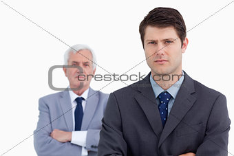 Close up of serious businessman with his mentor behind him