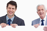 Close up of smiling businessmen holding blank sign
