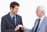 Close up of businessmen exchanging business card