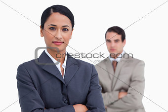 Saleswoman with arms crossed and colleague behind her