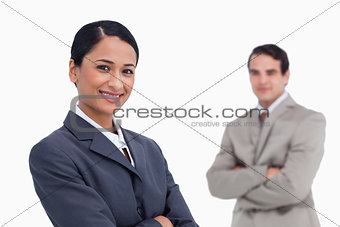 Smiling saleswoman with colleague behind her