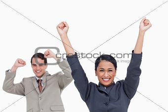 Cheering saleswoman with colleague behind her