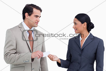 Saleswoman handing business card over to costumer