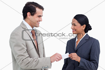Smiling business people exchanging business cards