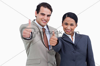 Smiling salespeople giving thumbs up