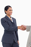 Smiling saleswoman shaking hand