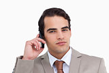Close up of serious salesman on his mobile phone