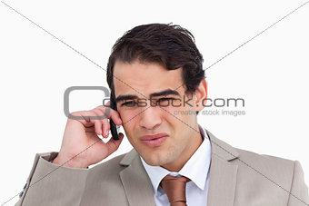 Close up of annoyed salesman on his cellphone