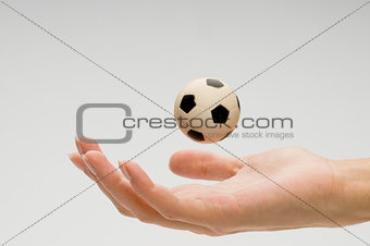 Soccer ball on female hand