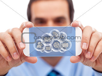 Businessman with smart gadget accessing cloud applications
