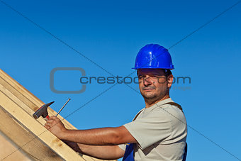 Proud construction worker on the roof