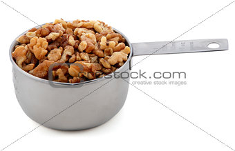 Chopped walnuts presented in an American metal cup measure