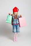 Happy young girl carrying Christmas shopping bags