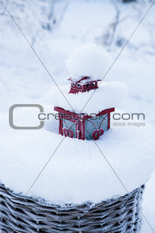 Red lantern in snow filled basket