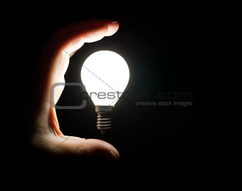 Light bulb and hand