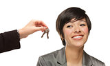 Mixed Race Young Woman Being Handed Keys on White