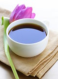 cup of black coffee and flower tulip