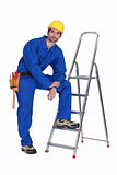 Handyman stood casually with ladder