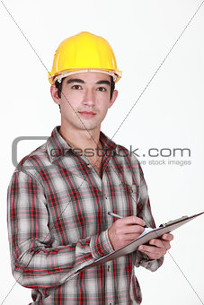 Man in a hardhat with a clipboard