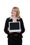 Blond woman presenting laptop