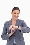 Smiling businesswoman looking at her watch