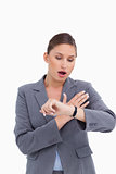 Shocked businesswoman looking at her watch