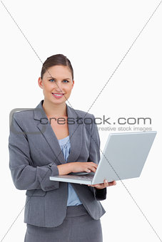 Smiling tradeswoman with her laptop