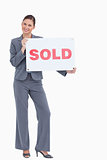 Happy real estate agent with sold sign