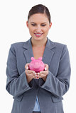 Smiling bank clerk with piggy bank