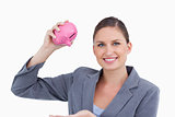 Smiling bank clerk with piggy bank in her hand