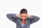 Close up of irritated tradeswoman covering her ears