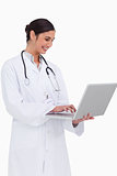 Side view of smiling doctor with her laptop