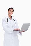 Smiling female doctor working on her laptop